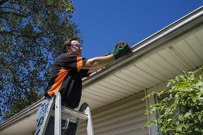 a damaged gutter being repaired by a professional in Bellbrook, OH