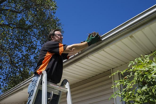 metal gutter pieces being carefully replaced and fixed in Germantown